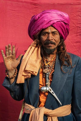 Sadhu with a titanium hip implant hanging around his Neck. He found it a a cremation site