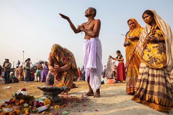 Pilgrims Performing a Puja Ritual after a Morning Dip in the Ganges