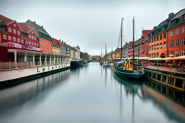 Nyhavn, a 17th-century façade & canal, in Copenhagen, Denmark. It is surrounded by brightly colored homes, cafes and restaurants,,The place is very crowded at times of the day so I took the photo at sunrise , used the Nisi Nd filter, to get the best scene possible!