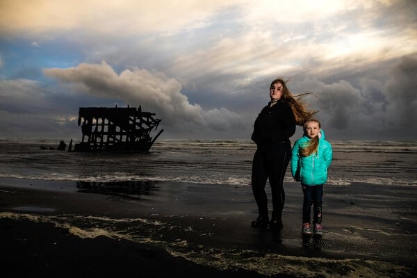 Sunset portrait in winter at Fort Stevens. Off camera flash and under exposed by 1 stop.