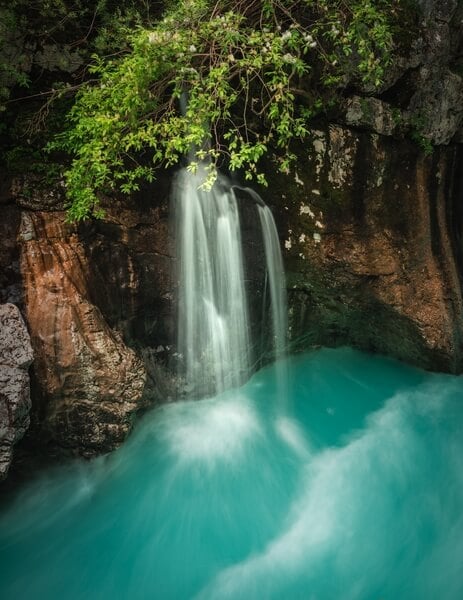 A small waterfall falling into the Soča river
