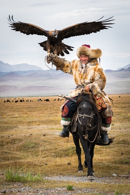 A proud senior Eagle Hunter in beautiful fur coat and hat.