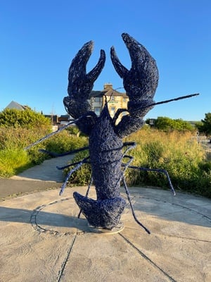 Lobster sculpture, framing the Captain Cook Inn
