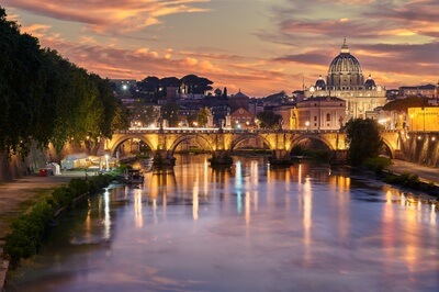 A view of St. Peter's Cathedral shoot from Ponte Umberto I at sunset with the city lights on
