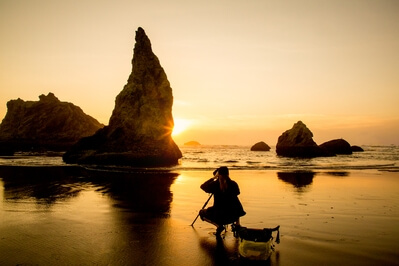 A fellow photographer catching the sunset behind the sea stacks.