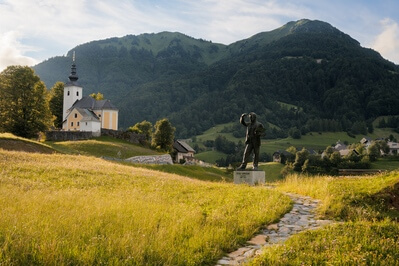 Spodnja Sorica - classic view with Lajnar, Dravh peaks, St Nicholas church and the Ivan Grohar statue - afternoon light