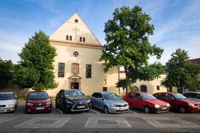 Capuchin Monastery in Opočno, with the cars parked in front of it