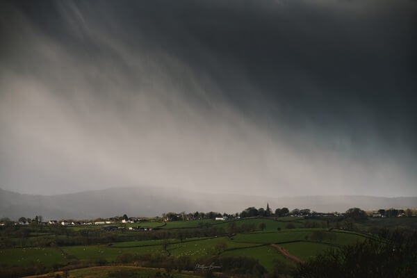 Snow showers over distant Llanddarog