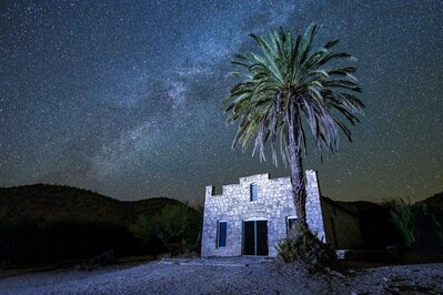 The old post office/store at the head of Big Bend National Park's Hot Springs has a wonderful palm tree standing in front of it, and it's the perfect composition for some beautiful photography. I was there in December, and my wife and I enjoyed some time in the hot springs (wonderful!) and watched the Milky Way rise and move around the sky so it would be in perfect position for this shot. I used a small LED panel to light the tree and the store front.
