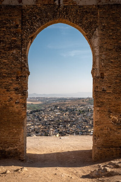 View at the old medina through an horseshoe shaped arch which used to be an entrance into one of the mausoleums.