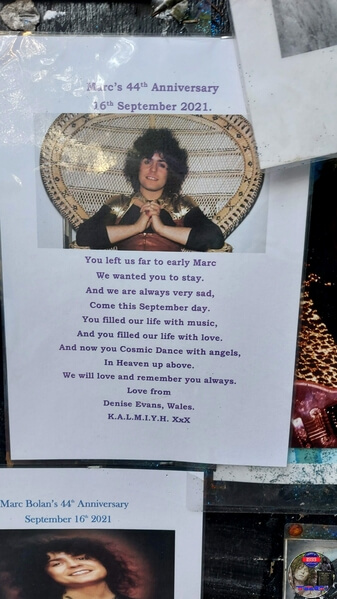 Tribute messages on the 'Memory Board' at Marc Bolan's Rock Shrine, Gipsy Lane, Barnes, SW15 5RG London. Photograph taken on the 16th September 2021 - The 44th Anniversary of his passing at this site. Marc's Shrine has been cared for since 1999 by TAG (T.Rex Action Group) via an in-perpetuity lease on the site. The PRS Memorial was installed in September 1997 for the 20th Anniversary. Five years later the bronze bust of Marc Bolan was installed for the 25th Anniversary. Both were unveiled by Marc Bolan's only heir Rolan Bolan who was just 10 days short of his second birthday when his dad died. That fateful night Rolan was asleep at his paternal grandparents home in Putney. Marc and his partner, Rolan's mother were on their way home at 142 Upper Richmond Road West, Sheen.  