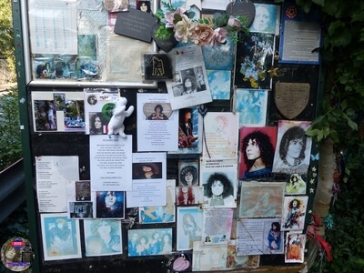 The 'Memory Board' overflowing with tribute messages. The oldest one still there days from 2000, at Marc Bolan's Rock Shrine, Gipsy Lane, Barnes, SW15 5RG London. Photograph taken on the 16th September 2021 - The 44th Anniversary of his passing at this site. Marc's Shrine has been cared for since 1999 by TAG (T.Rex Action Group) via an in-perpetuity lease on the site. The PRS Memorial was installed in September 1997 for the 20th Anniversary. Five years later the bronze bust of Marc Bolan was installed for the 25th Anniversary. Both were unveiled by Marc Bolan's only heir Rolan Bolan who was just 10 days short of his second birthday when his dad died. That fateful night Rolan was asleep at his paternal grandparents home in Putney. Marc and his partner, Rolan's mother were on their way home at 142 Upper Richmond Road West, Sheen.  