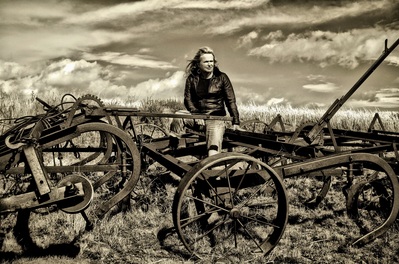 My cousin is a singer needing a photo for one of her future CD's.  Here she is on one of the old cultivating tools left abandoned.