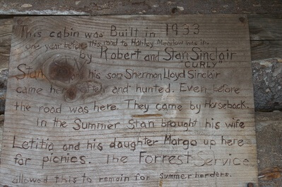 Sign over the door of the log cabin at Haney Meadows