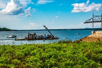 The local fishermen's cooperative operates a barge to collect seafood and deliver it to market.