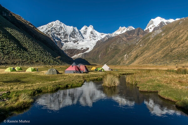 Camp next to the Laguna Jahuacocha, at 4.050 m., in the background the highest mountains of the Cordillera Huayhuash.