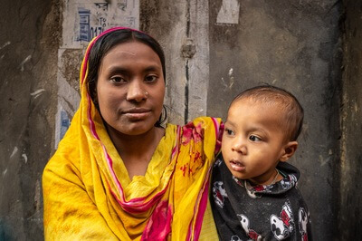Woman from the neighboring slum with her child