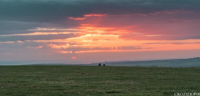 Couple watch the sunset from Ditchling Beacon