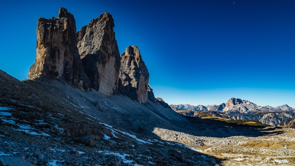 Just got over the highest point of our hike. The Tre Cime rises up massifly. 