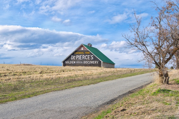 It is found just west of the town of Waterville as you're leaving on the north side of Highway 2.  From this vantage point, you can also see another barn that is similarly painted with an advertisement which is situated due west and a little south of this barn.