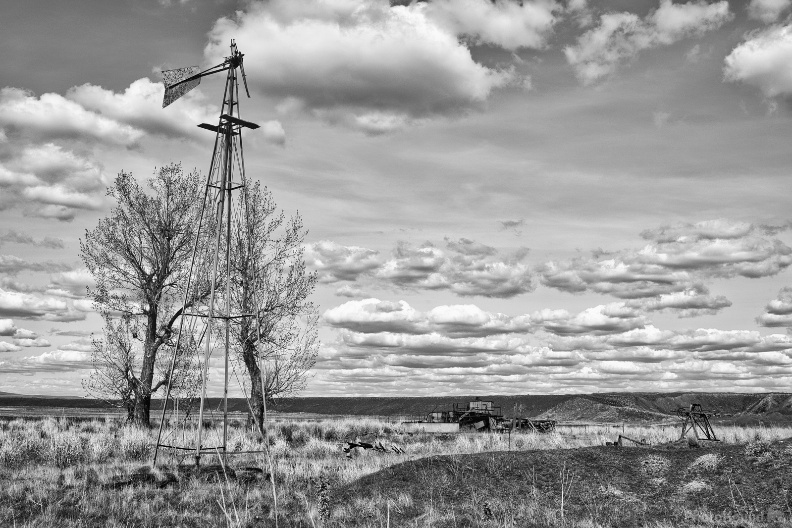Image of Old Farm Implement and Windmill Frame by Steve West