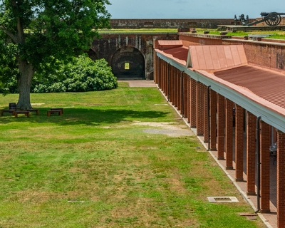 View along the interior side of the east rampart and eastern edge of the parade ground facing south toward the Southwest Bastion. The cannon at the upper right are atop the Southwest Bastion.