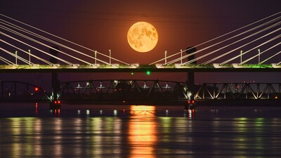 A full moon rises behind the Ed Hendler Cable Bridge in Tri Cities, WA.