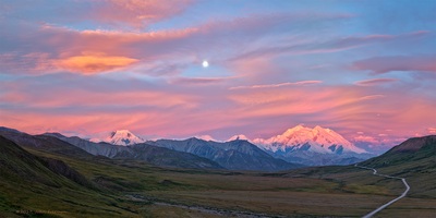 Aug. 9, 2017, 4:36AM. My friend Bill and I had woke up at 2:30AM to drive the 30 miles from Teklanika River Campground to Stony Hill Overlook. The evening before we had consulted GPS data and determined the just past full moon would be nearly over the top of Mt. Denali at sunrise. At the campground we had overcast skies but we decided to go anyway trusting the Lord would give us clear skies at Stony Pass. While the scene He painted for us when we arrived at Stony Pass wasn't the perfectly clear skies I had envisioned in my head, what He gave us was beyond anything I could have imagined. As the sun neared the horizon the Alpen Glow painted the clouds and mountains with hues of pinks to orange while the nearly full moon hung suspended above the peaks. The light of the Alpen Glow reflected into the valley below Stony Pass illuminating the tundra, that was just starting to show signs of fall colors, intensifying the colors of the tundra foliage.The original un-cropped version of this panorama consists of 12 individual HDR 42 mega-pixel images shot with Sony a7Rii at f-11, bracketed .4, 1/10th, & 1.6 seconds and ISO 100 using a 100mm lens yielding an image 39 x 70. The cropped image as shown is:    219 Mega-pixels    10456 x 20912 pixels    34.8 x 69.7 300 ppi original size