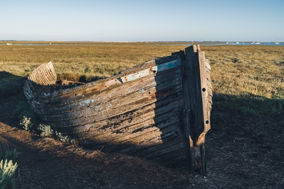 Decaying wooden boat on the coastal path heading east.