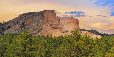 The late afternoon sunlight was blocked from Crazy Horse Mountain but had set the overhead clouds aglow in golden light making Crazy Horse shine with a a golden hue. This is a focus bracketed set of images, consisting of a total of 159 shots, The finished focus stack yielded 24 images in a 3 row x 8 column set. These were stitched into a 121 cm x 244cm (48 x 96) 403 megapixel Wall Mural. Shot with Canon R5, 300mm f/4 lens,  f/11. 1/160 sec., ISO 125