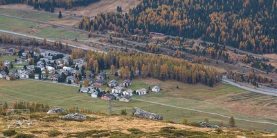 The village of Muragl and the Bernina train passing by
