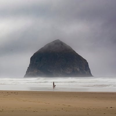 This stack is sometimes called the 2nd Haystack on the Oregon coast (the Canon Beach one has the edge on fame), and sometimes with its alternative name of Chief Kaiwanda Rock. This one is near Pacific City. People have noted that often it appears to float in the air. I liked this shot with the man and his dog giving it scale, and the floating image on this foggy day.