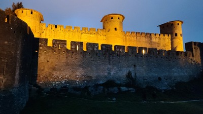 Inner walls light up after dark. Carcassonne castle.