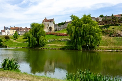 From the far side of l'Ante, the river that runs through Falaise and looking back towards the old town walls. In the centre, between the two trees, is the Porte des Cordeliers, the last remaining 'gate'