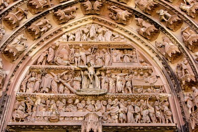 A detail shot of the frieze above the main entrance. If you look to the left of the outstretched arm of Jesus, you can see someone mooning, with a boy standing on his back. Not something you'll find in the guidebook - I have friends in Strasbourg who pointed it out.