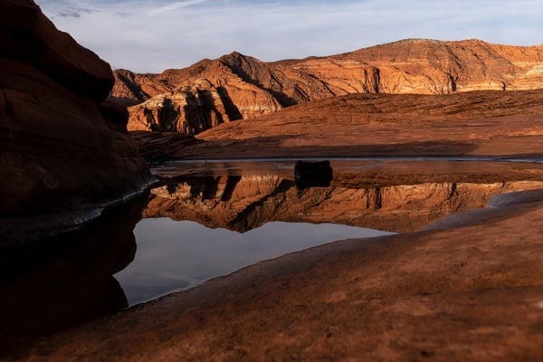 Just enough ice-free to catch an early morning reflection from the Petrified Dunes.