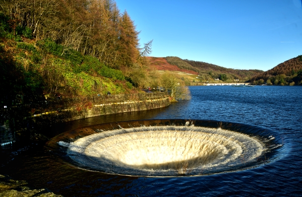 The Ladybower plughole overflowing at a very fast rate and roaring loudly.