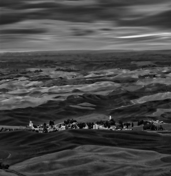 Steptoe Butte is a must visit when in the area.  Looking west from the butte I made a modest photo before the edit. With Photoshop I lowered texture so that the hills lost detail and looked more wave-like. The sky was given a motion blur to echo the feeling of waves. NiK Collection gave me choices for the BW.