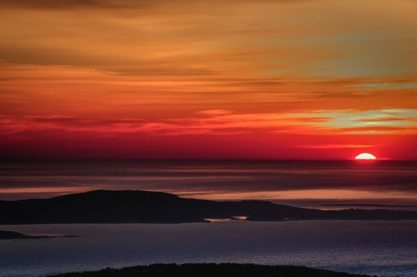 Atop Cadillac Mtn. at sunrise.  Being the highest point on the Eastern seaboard, it is here that the sun first rays shine upon USA