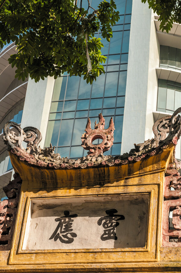 Maison Centrale Gate with modern Hanoi Towers