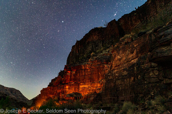 Campfire glow on the canyon wall