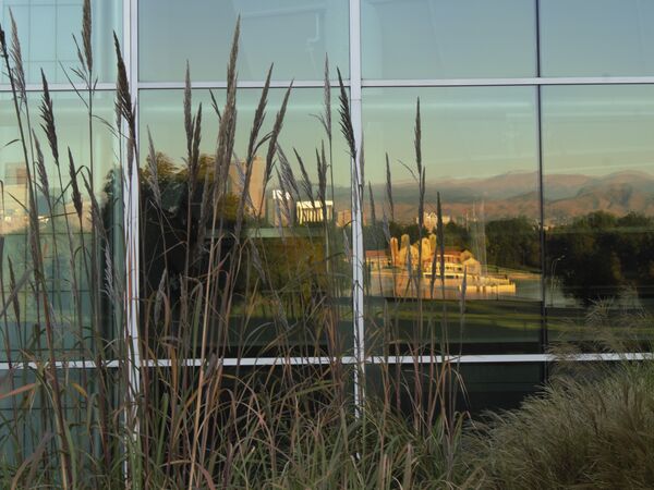Always look behind!Ferril Lake, City Park Pavilion, Skyline, and Rocky Mountains reflected in expansive glass along the museum West patio. Sony Alpha 58 kit lens 55 mm f/14 1/15 Second ISO-100