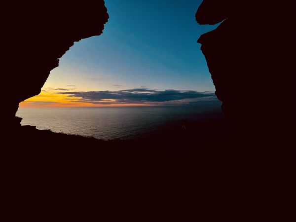 Sunset at Valley of Rocks looking out into Bristol Channel through rock formation