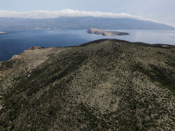 Tito sign on Sveti Grgur island. Goli otok in the background