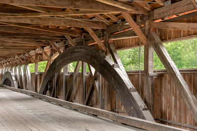 The bridge has a unique suspension system that includes laminar wooden trusses.