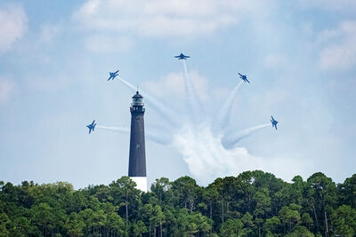 One of the Blue Angels signature moves as photographed from Ft. Pickens, the Pensacola lighthouse makes a nice additional element.