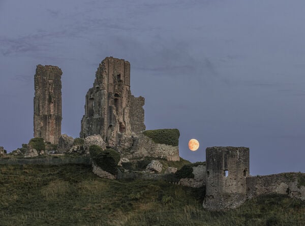 Gibbous moon rising over the castle