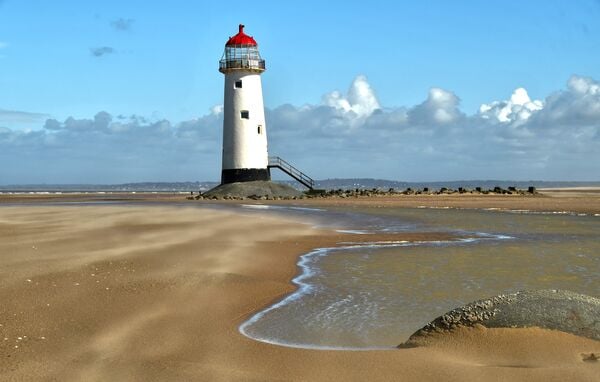 The lighthouse on the beach. Now restored externally to its former glory