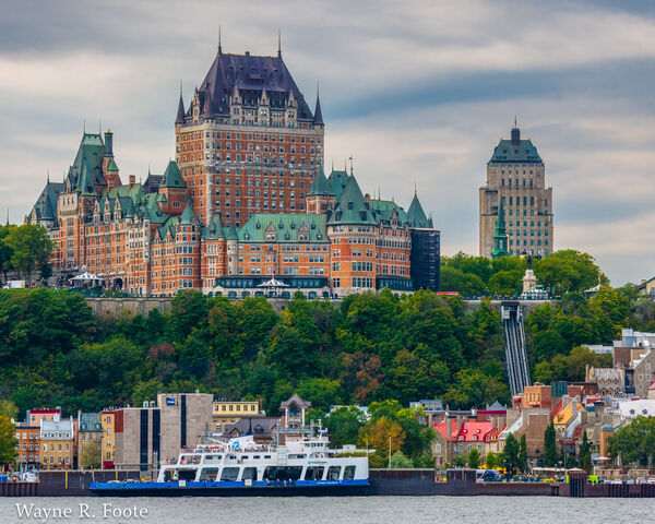 The Chateau Frontenac Hotel dominates the Old Quebec skyline. The blue and white ship below the hotel is one of the two ferry boats.