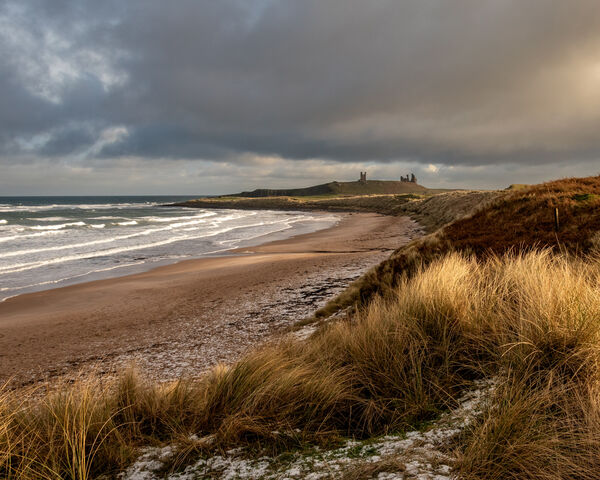 Winter view of Dunstanburgh Castle from Embleton Bay